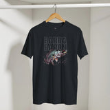 Black t-shirt with fish graphic and 'Barra Baron' text on a hanger against a white wall.