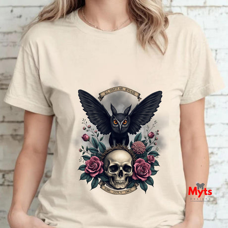 A Woman wearing a t-shirt with a black owl and skull design on a white brick wall background