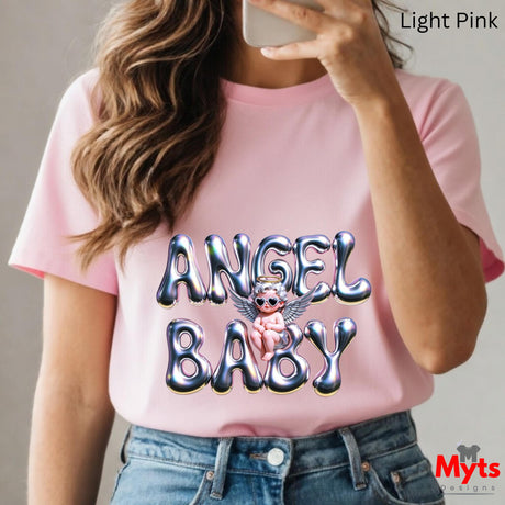 Person wearing a pink t-shirt with 'Angel Baby' design, holding a phone.