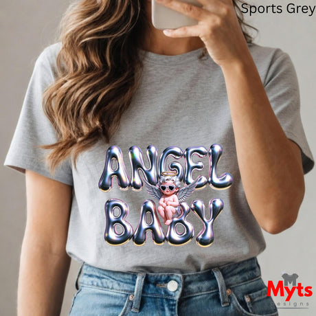 Person wearing a gray t-shirt with 'Angel Baby' design, holding a phone.