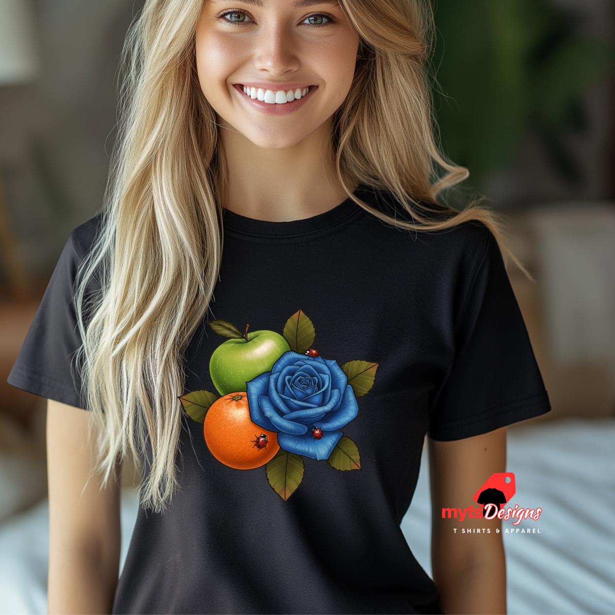 Woman wearing a black t-shirt with colorful floral design, smiling indoors.