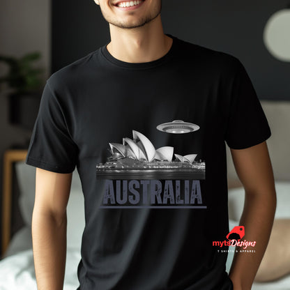 Front view of a young man wearing a soft black casual tee showing the Sydney Opera House sails with a sleek spaceship graphic orbiting overhead, printed on ultra-soft Gildan 64000 cotton.