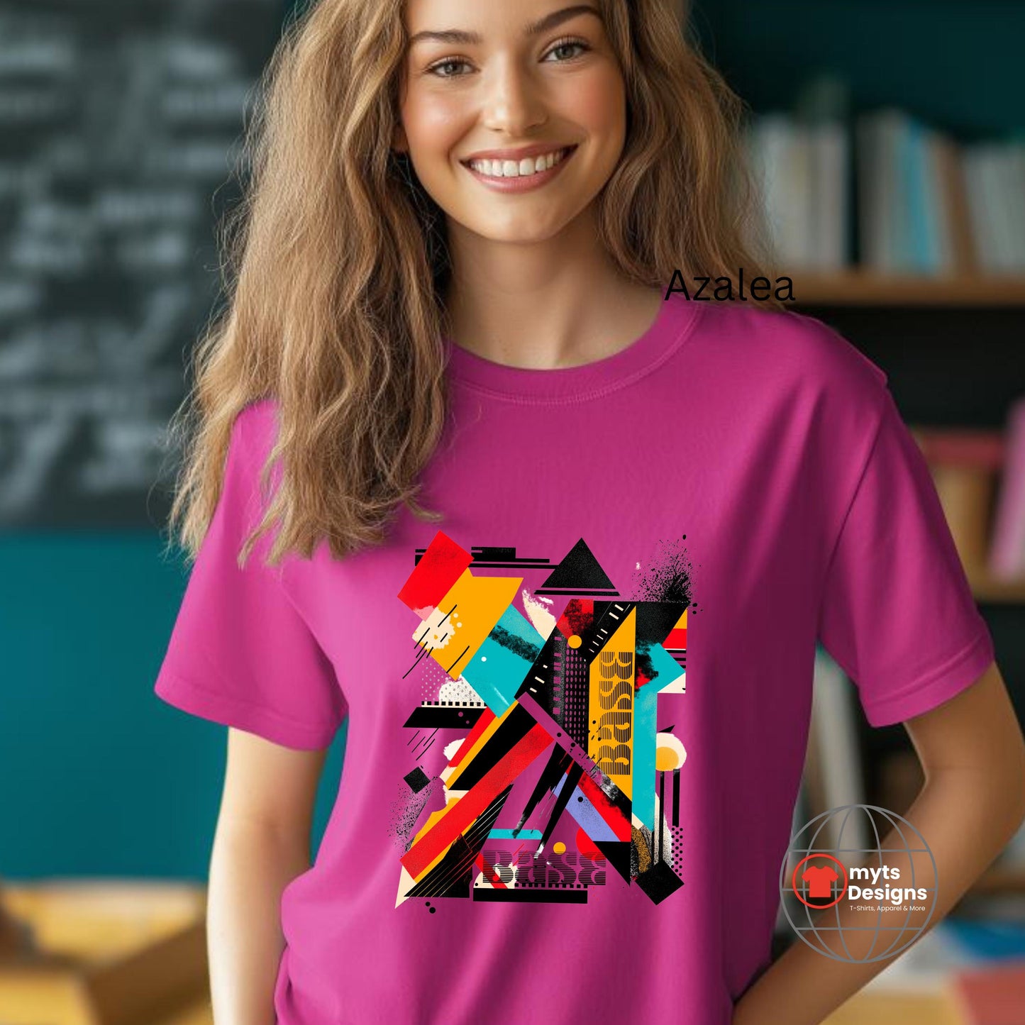 Person wearing a pink t-shirt with colorful geometric design in an indoor setting