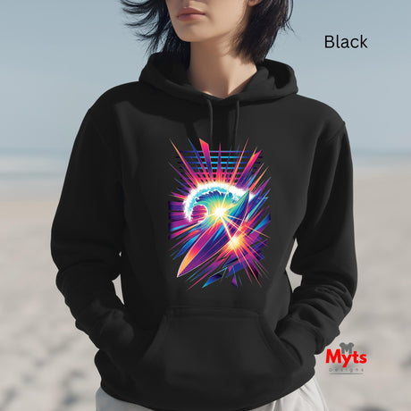 Person wearing a black hoodie with a colorful abstract design on a beach.