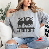 Person wearing a gray sweatshirt with cow graphic and 'An Udder Story' text, sitting on a couch.