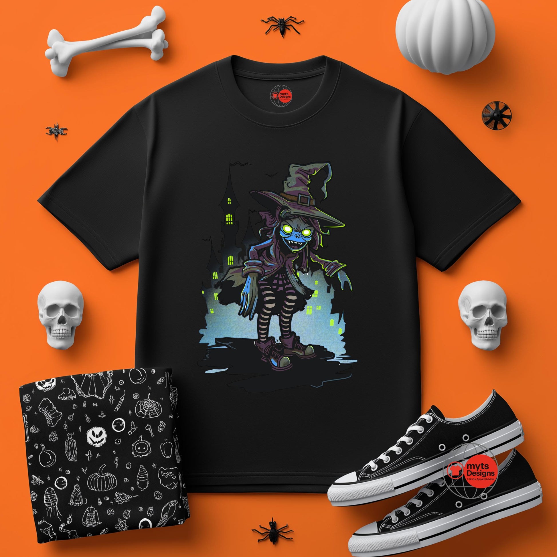Black t-shirt with a witch graphic on an orange background with Halloween-themed items.
