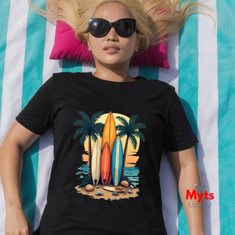 Person wearing a black t-shirt with a beach-themed design, lying on a striped towel.