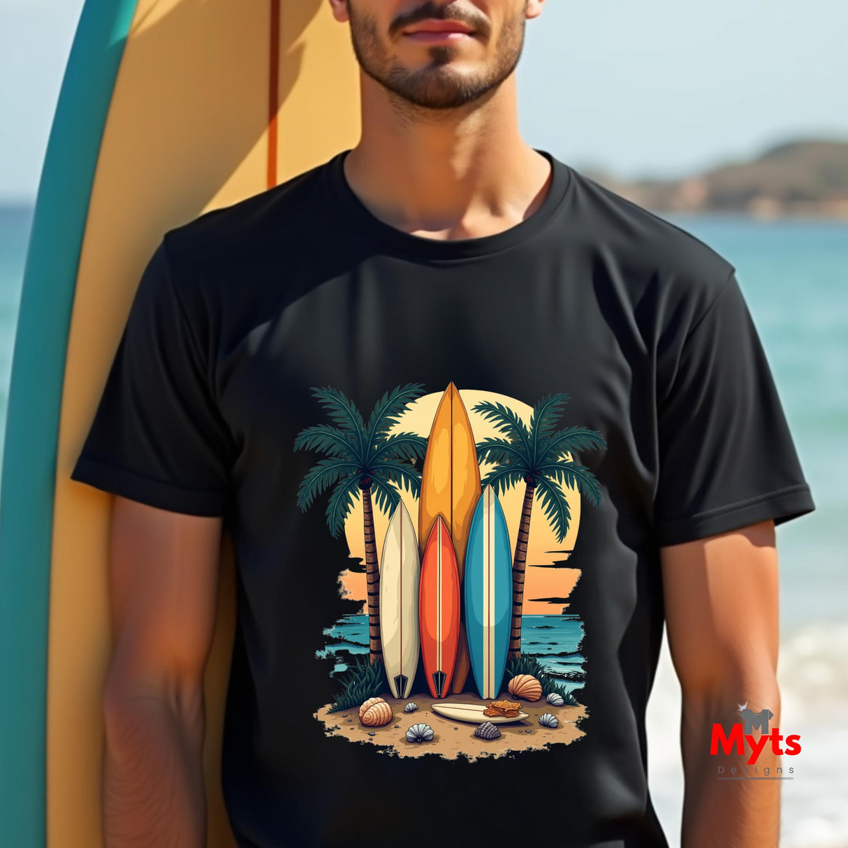 Person wearing a black t-shirt with a surfboard and palm tree design, standing by a surfboard on a beach.