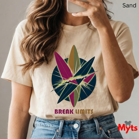 Person wearing a sand t-shirt with a colorful graphic and 'Break Limits' text, holding a phone.