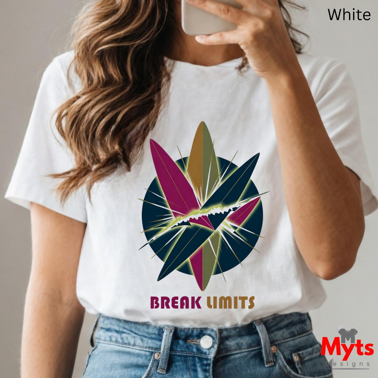 Person wearing a white t-shirt with a colorful graphic and 'Break Limits' text, holding a phone.