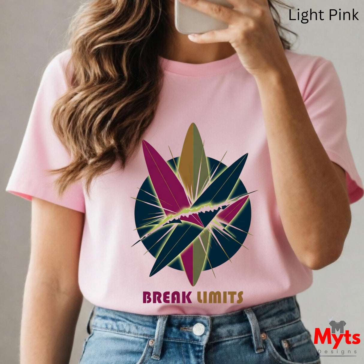 Person wearing a pink t-shirt with a colorful design and 'Break Limits' text, taking a selfie.