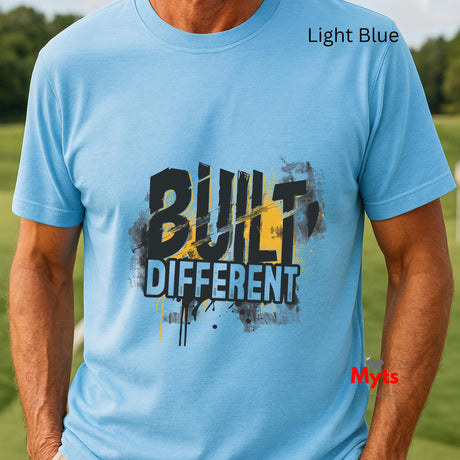 Light blue t-shirt with 'Built Different' text worn by a person outdoors.