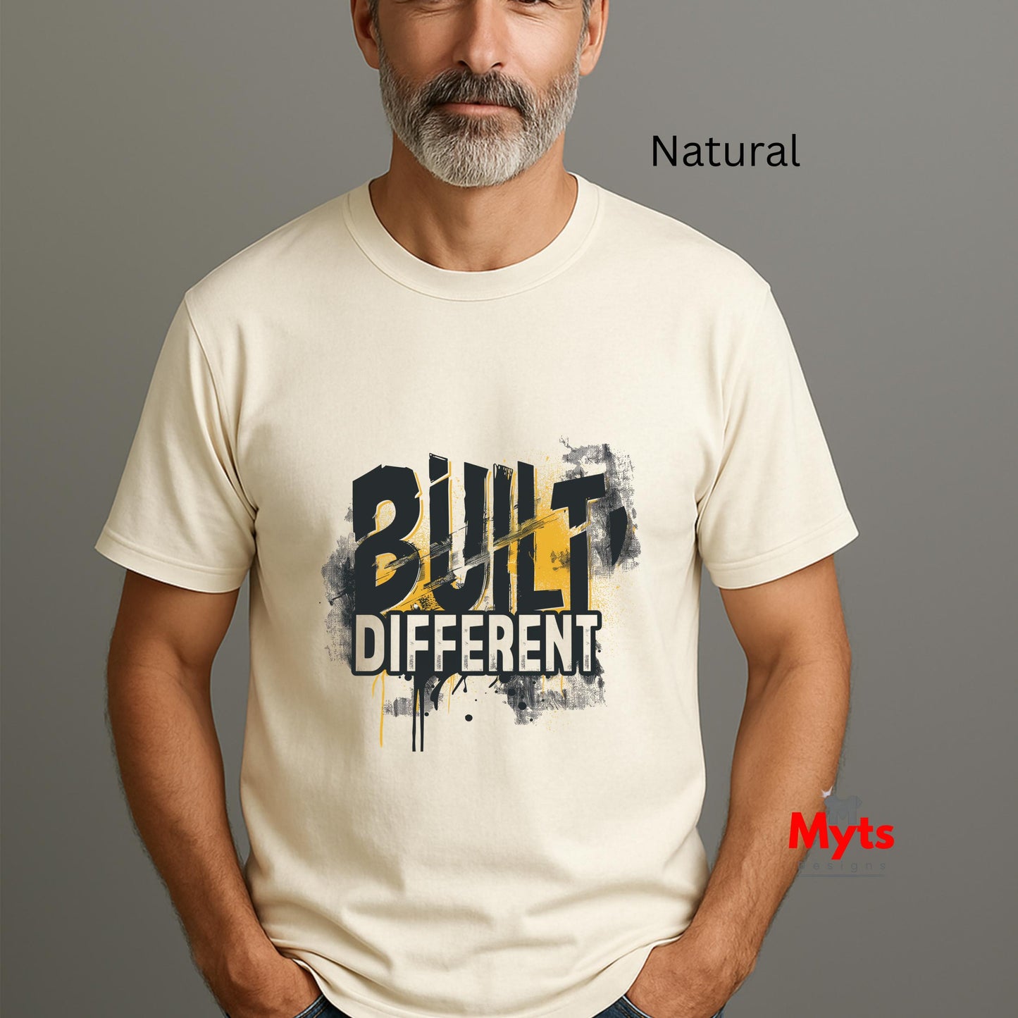 Man wearing a white t-shirt with 'BUILT DIFFERENT' text on a gray background