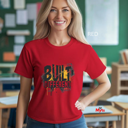 Woman wearing a red t-shirt with 'Built Different' design in a classroom setting