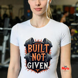 Person wearing a white t-shirt with 'Built Not Given' graphic and barbell design in a gym setting.