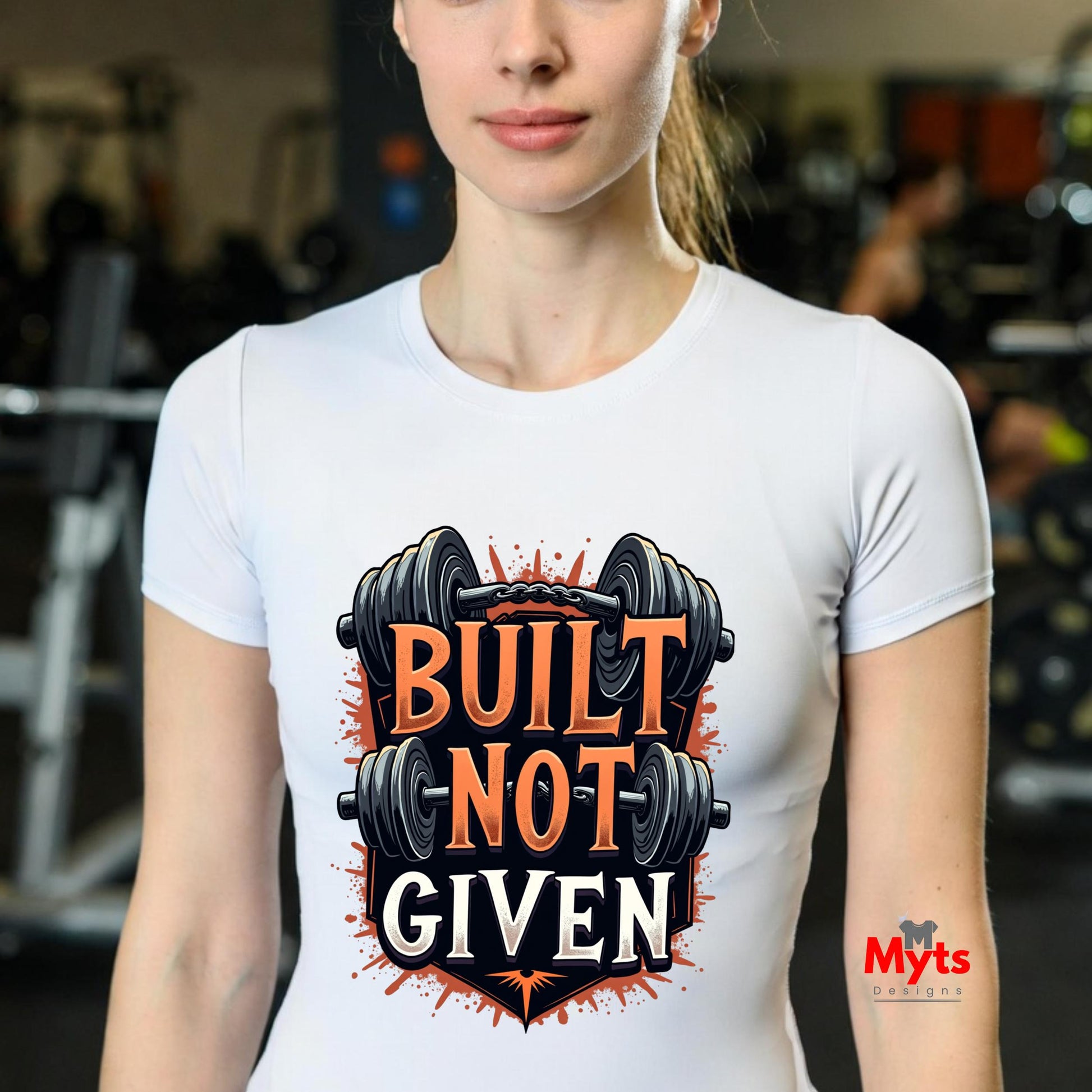 Person wearing a white t-shirt with 'Built Not Given' graphic and barbell design in a gym setting.