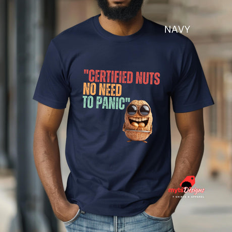 A man wearing a navy colored Retro-style casual tee featuring bold vintage script reading “Certified Nuts, No Need to Panic” in distressed lettering, printed on ultra-soft Gildan 64000 cotton.

