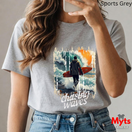 Person wearing a gray t-shirt with a graphic design and text, taking a selfie.