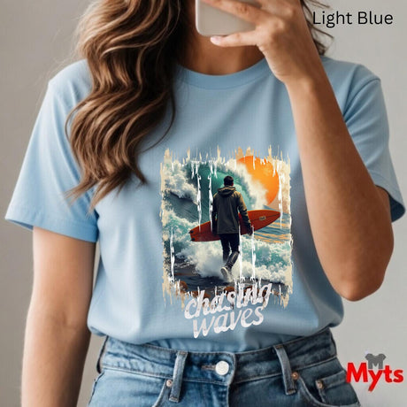 Person wearing a light blue t-shirt with a graphic design and text, taking a selfie.