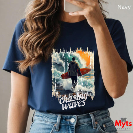Person wearing a navy t-shirt with a graphic design and text, holding a phone.