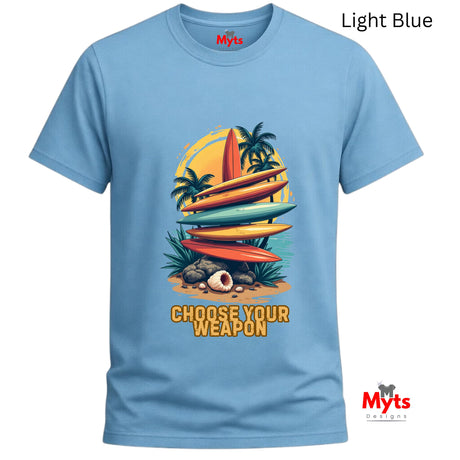 Light blue t-shirt with a graphic design of surfboards and palm trees, featuring the text 'Choose Your Weapon'.