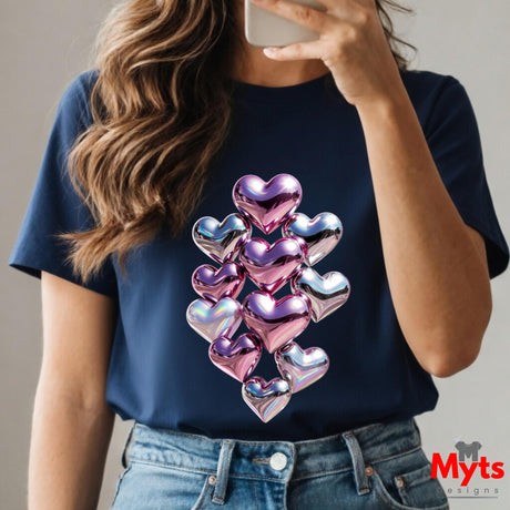 Person wearing a navy blue t-shirt with colorful heart design, taking a selfie.