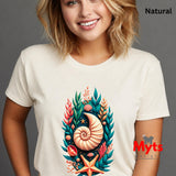 A woman wearing a natural off-white t-shirt with a colorful graphic print of a nautilus shell, starfish, and coral. The text 'Natural' is visible in the top right corner, and a watermark 'Myts design' is visible on the bottom right.
