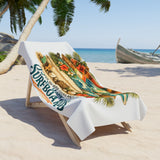 Beach towel with surfboard design on a lounge chair at the beach