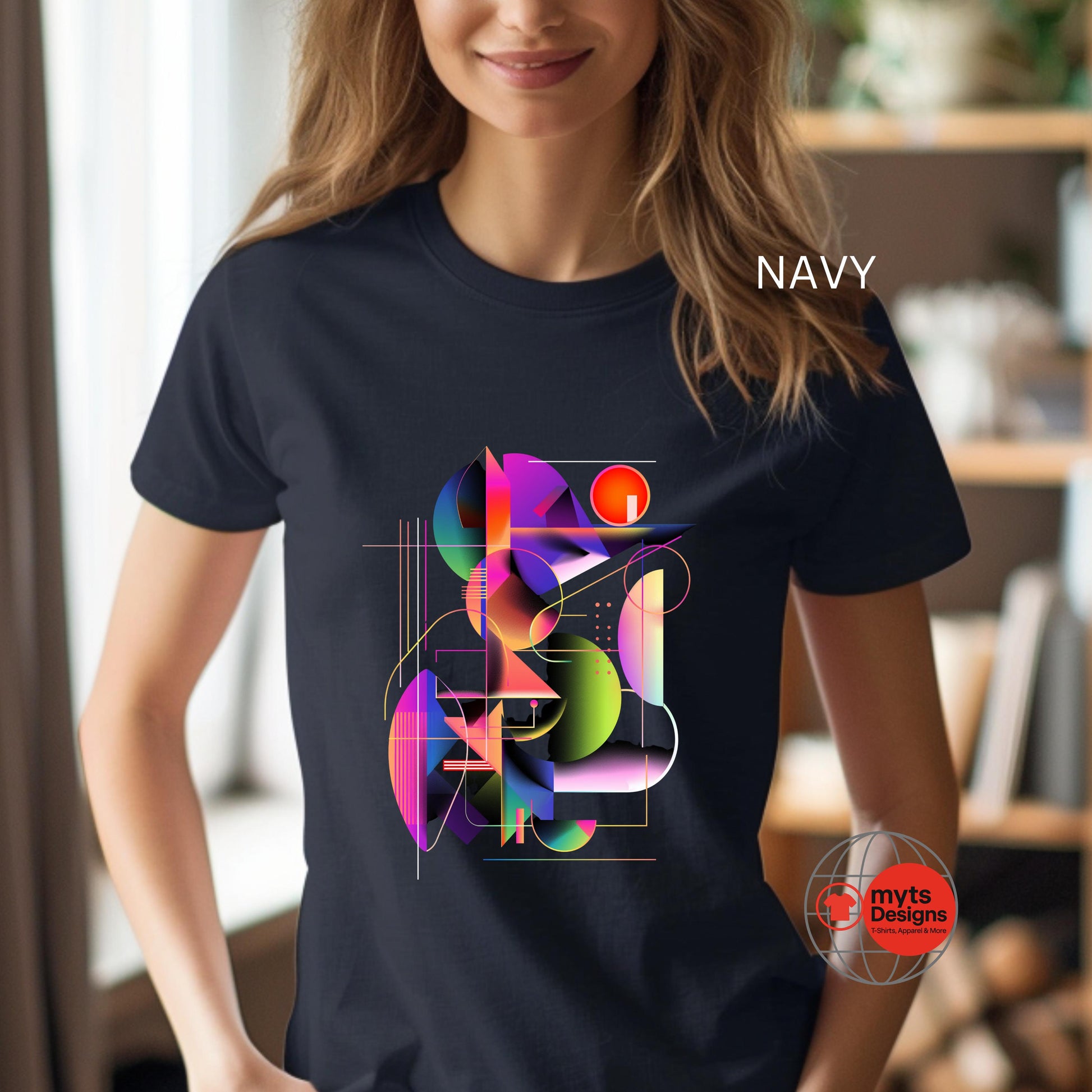 Person wearing a navy t-shirt with a colorful geometric design, standing indoors.