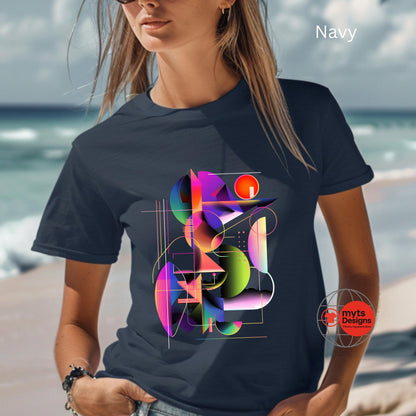 Person wearing a navy t-shirt with a colorful geometric design by the sea.