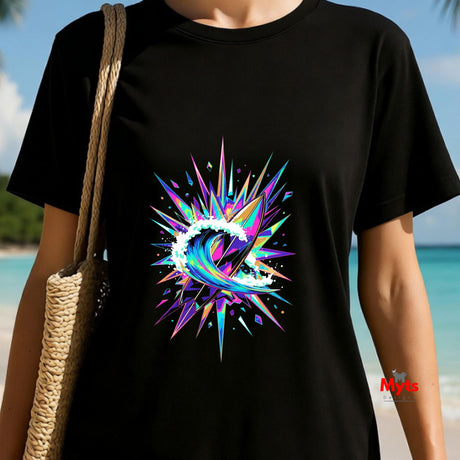 Person wearing a black t-shirt with a colorful abstract design on a beach.