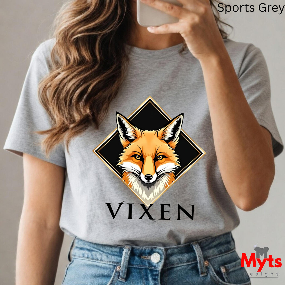 Person wearing a gray t-shirt with a fox graphic and 'VIXEN' text, holding a phone.