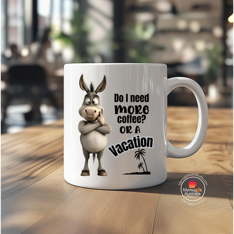 Ceramic coffee mug featuring a cartoon donkey with folded arms and the humorous quote “Do I Need More Coffee or a Vacation?” Ideal novelty gift for coffee lovers, office workers, and animal enthusiasts.