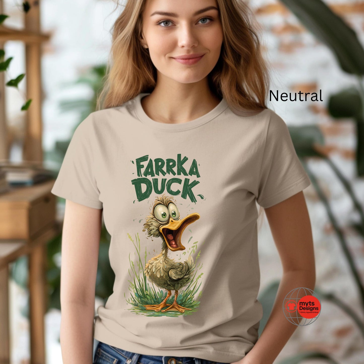 Woman wearing a t-shirt with 'Farka Duck' graphic design in an indoor setting.