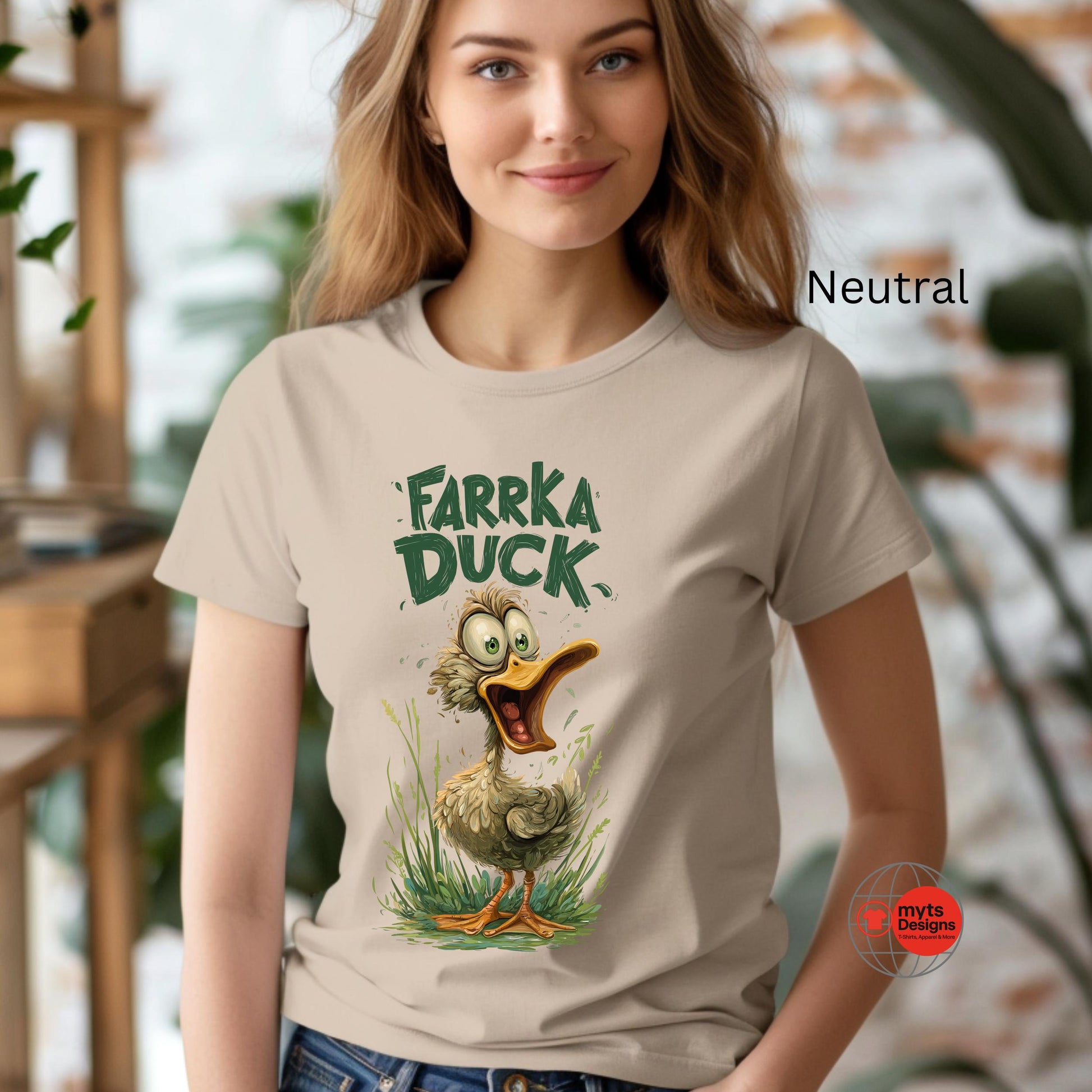 Woman wearing a t-shirt with 'Farka Duck' graphic design in an indoor setting.