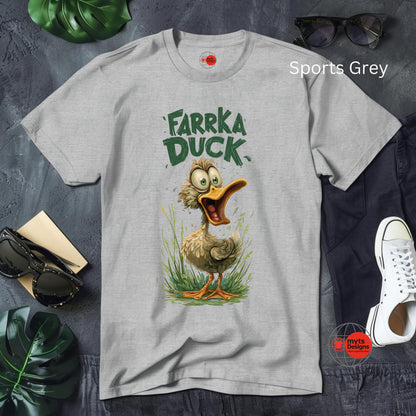 Gray t-shirt with a cartoon duck design and text on a gray surface with accessories.
