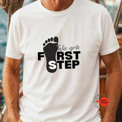 White t-shirt with black footprints and text 'Take your first step' on a blurred background