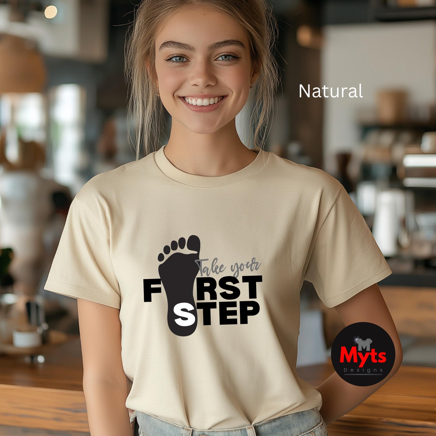 A woman wearing a Natural t-shirt with a motivational message in a casual setting