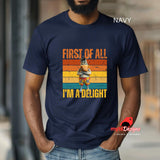 A man at a hall wearing a navy "first of all I'm a delight" funny donkey t-shirt