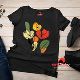 Black t-shirt featuring minimalist floral line art with abstract red, yellow, and orange flowers and green leaves, laid flat on a wooden surface with rolled sleeves.