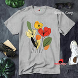 Sports Grey t-shirt featuring minimalist floral line art with abstract red, yellow, and orange flowers and green leaves, laid flat on a wooden surface with rolled sleeves.