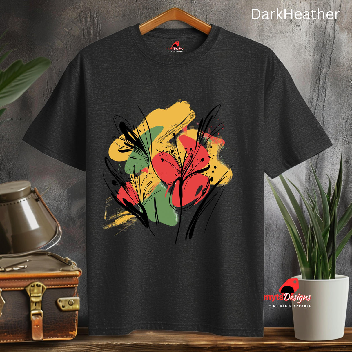 Black T-shirt with bold abstract floral design featuring red blooms, yellow and green brushstrokes, and black line art accents, from MytsDesigns.com