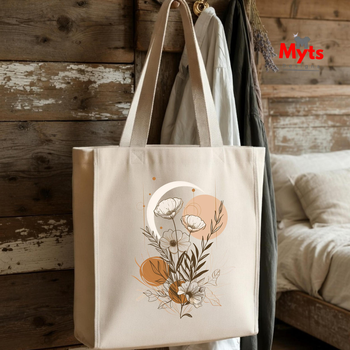 Beige tote bag with floral design hanging on a wooden wall