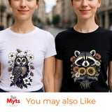 Two women wearing graphic t-shirts, one in white with an owl and flower design and one in black with a raccoon and flower design, set against a blurred street background. A banner at the bottom reads 'Myts You may also Like'.