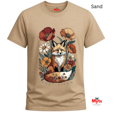 A sand-colored crewneck t-shirt featuring a detailed graphic of a fox surrounded by wildflowers, with the text 'FOXY VIXEN' printed below. The brand name 'Myts' is visible on the inner neck label and as a watermark in the bottom right corner.
