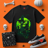 Black t-shirt with green witch design on an orange background with Halloween-themed accessories.