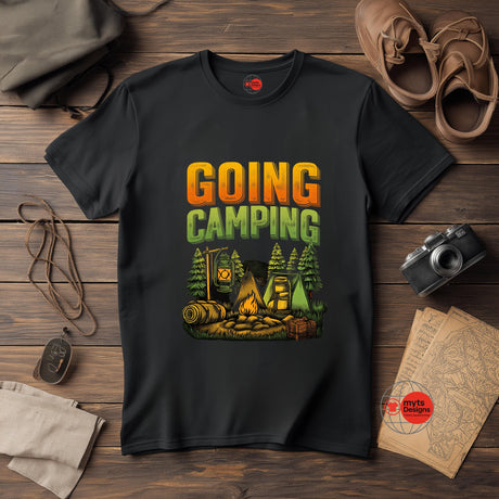 Black t-shirt with 'Going Camping' graphic on a wooden surface with camping-themed items.