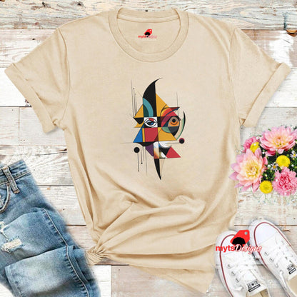 “Natural unisex T-shirt featuring an abstract geometric face design inspired by Picasso’s Cubist art, with bold shapes and vibrant colors, Flat lay on wooden background, available from MytsDesigns.com”