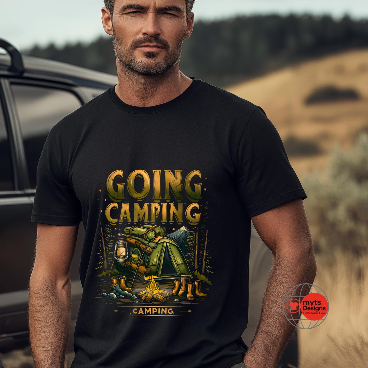 Man wearing a black t-shirt with 'Going Camping' graphic design outdoors.