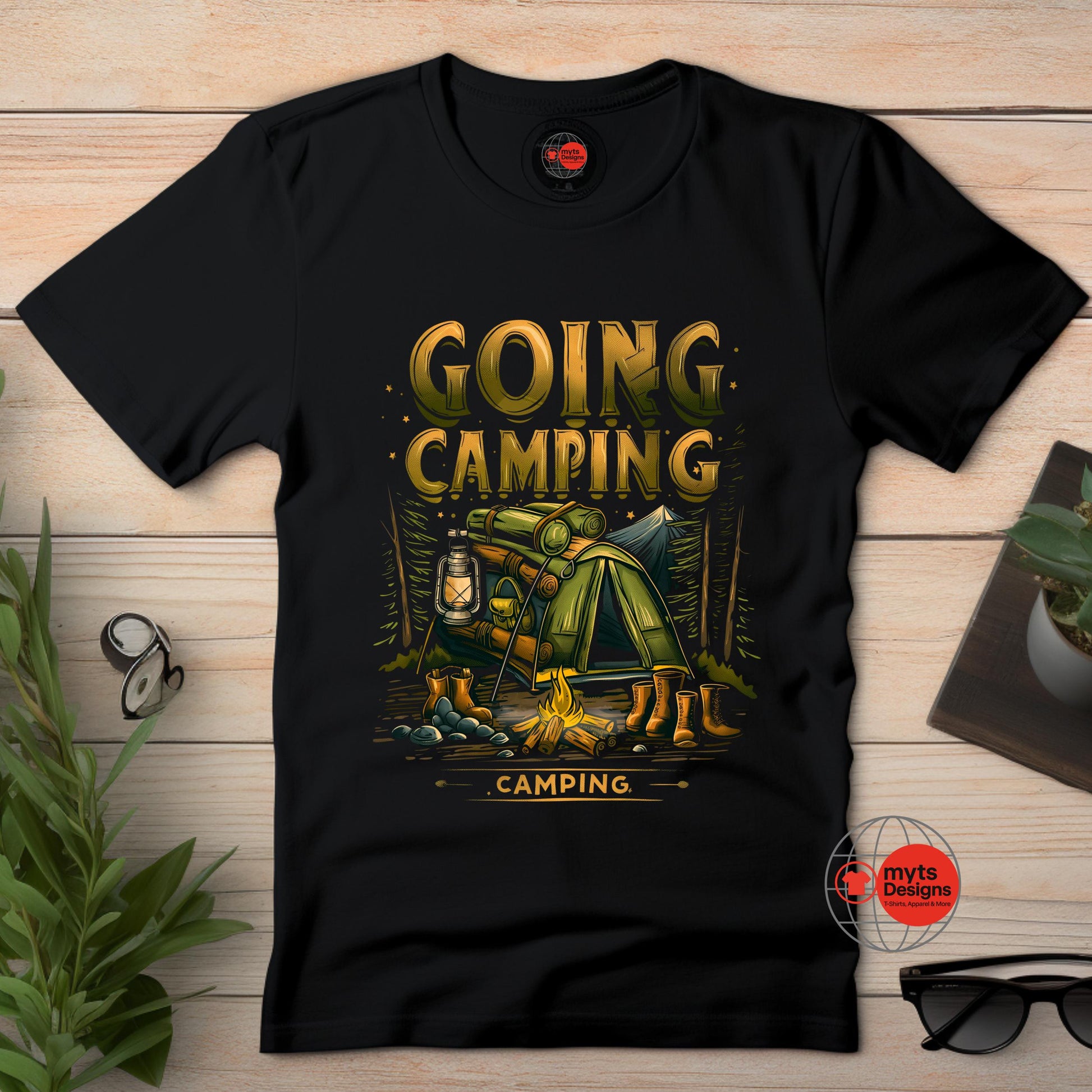 Black t-shirt with 'Going Camping' graphic design on a wooden surface.